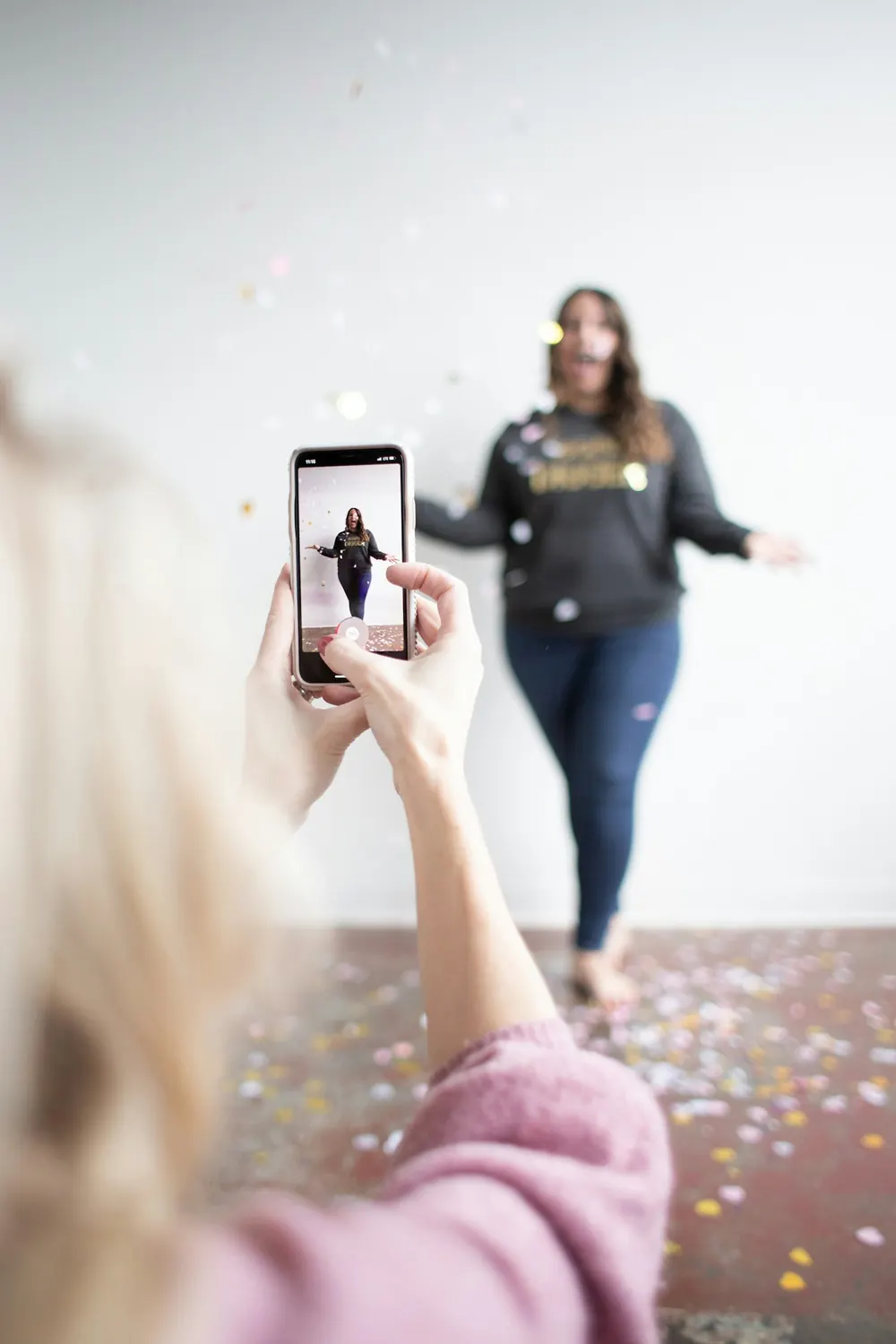 A product shoot: someone taking a photo with a phone