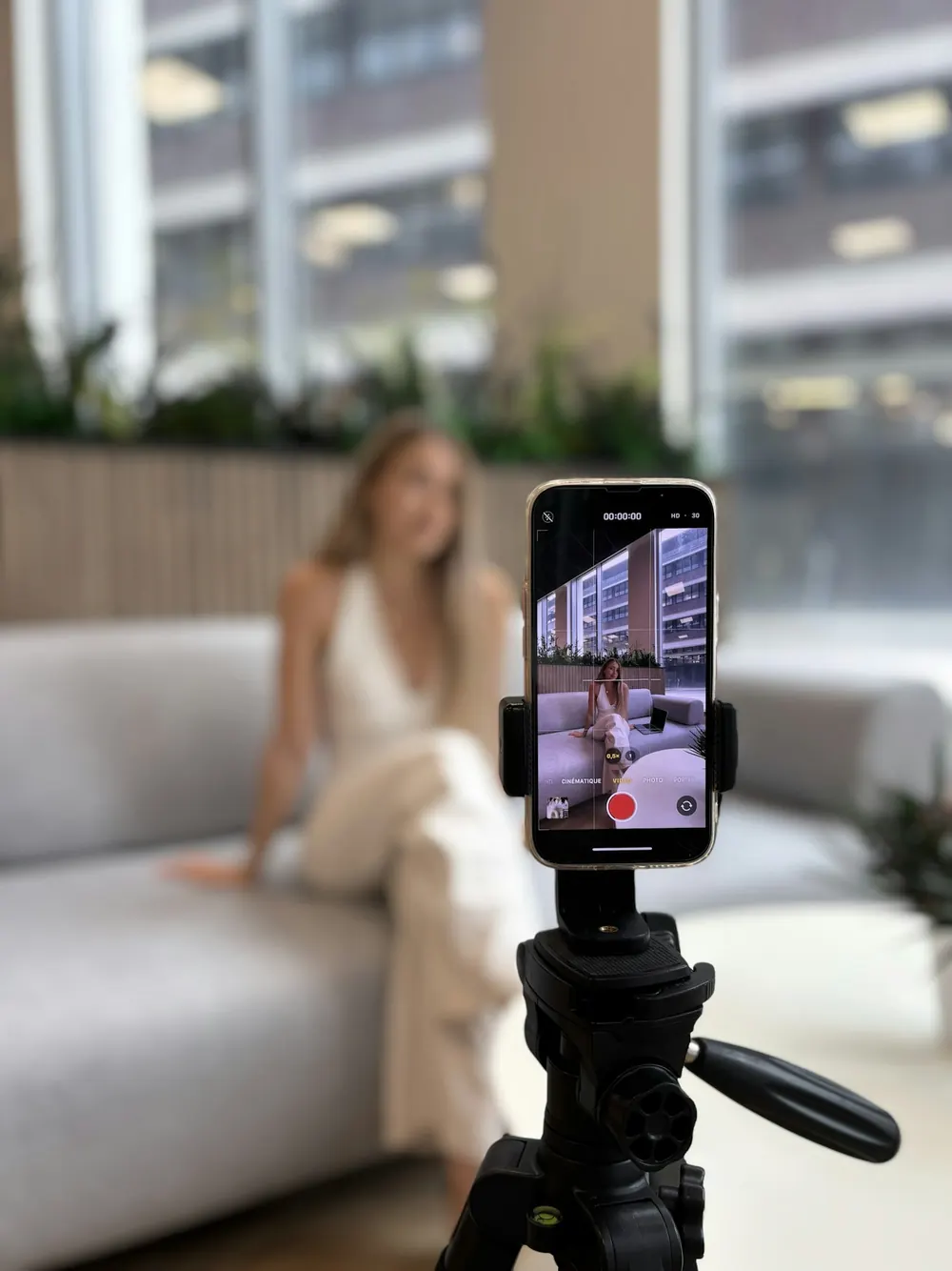 A creator recording a video with a phone on a tripod